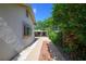 A side view of the home featuring a brick path and a view of the covered parking area at 1621 Sunnyside Dr, Maitland, FL 32751