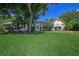 Charming one-story home with lush green lawn, mature tree, and well-maintained landscaping at 1621 Sunnyside Dr, Maitland, FL 32751