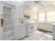 Efficient white kitchen features ample cabinetry, modern appliances, and bright, natural light at 1621 Sunnyside Dr, Maitland, FL 32751