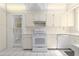 Efficient white kitchen features ample cabinetry, modern appliances, and bright, natural light at 1621 Sunnyside Dr, Maitland, FL 32751