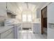 Efficient white kitchen features ample cabinetry, modern appliances, and bright, natural light at 1621 Sunnyside Dr, Maitland, FL 32751