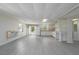 Open concept living room and kitchen with grey plank floors and light walls at 1621 Sunnyside Dr, Maitland, FL 32751