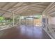 Inviting screened porch with brick flooring and white railing offers a relaxing outdoor space at 1621 Sunnyside Dr, Maitland, FL 32751