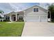 Charming home featuring a well-manicured lawn and a two-car garage at 1637 Mistflower Ln, Winter Garden, FL 34787