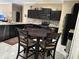 Open kitchen with dark cabinets, stainless steel appliances, and breakfast table at 1637 Mistflower Ln, Winter Garden, FL 34787