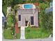 Aerial view of the property featuring an in-ground pool, fire pit, luscious landscaping, and large lawn at 1653 Cheyenne Trl, Maitland, FL 32751