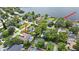 Stunning aerial view showcasing a beautiful home with a pool and lake access, offering a luxurious waterfront lifestyle at 1653 Cheyenne Trl, Maitland, FL 32751