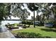 Lakeside backyard featuring a picnic area, BBQ, and kayak storage, ideal for outdoor gatherings and water activities at 1653 Cheyenne Trl, Maitland, FL 32751