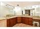 Bathroom vanity features wood cabinets and marble countertops with an inset stool at 1653 Cheyenne Trl, Maitland, FL 32751