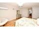 Bright bedroom featuring hardwood floors, a chandelier, and ensuite bathroom access at 1653 Cheyenne Trl, Maitland, FL 32751