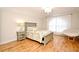 Bedroom featuring hardwood floors, chandelier, and a cozy papasan chair at 1653 Cheyenne Trl, Maitland, FL 32751