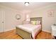 Charming bedroom with hardwood floors, a comfortable bed, dresser, and a bright window at 1653 Cheyenne Trl, Maitland, FL 32751