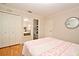 Bedroom featuring hardwood floors and a peek into the en-suite bathroom, offers a private retreat at 1653 Cheyenne Trl, Maitland, FL 32751