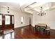 Bright dining area with hardwood floors, a decorative chandelier, and coffered ceilings for elegant meals at 1653 Cheyenne Trl, Maitland, FL 32751