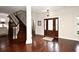Elegant foyer with hardwood floors, staircase, and decorative front door at 1653 Cheyenne Trl, Maitland, FL 32751