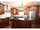 Upscale kitchen featuring granite counters, modern appliances, stainless steel refrigerator, and gas range at 1653 Cheyenne Trl, Maitland, FL 32751