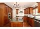 Spacious kitchen with dark wood cabinets, modern appliances, and a center island for gourmet cooking at 1653 Cheyenne Trl, Maitland, FL 32751