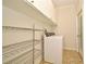 Functional laundry room with storage shelving and a modern washing machine at 1653 Cheyenne Trl, Maitland, FL 32751