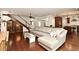 Open-concept living room with hardwood floors, large sectional sofa, and kitchen view at 1653 Cheyenne Trl, Maitland, FL 32751