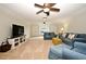 Spacious living room with large windows, ceiling fans, and comfortable denim seating at 1653 Cheyenne Trl, Maitland, FL 32751