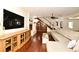 Spacious living room featuring hardwood floors, a fireplace, and stairs with custom wine storage at 1653 Cheyenne Trl, Maitland, FL 32751