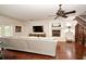 Comfortable living room with hardwood floors, fireplace, and staircase with custom wine storage at 1653 Cheyenne Trl, Maitland, FL 32751
