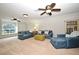 Spacious living room with large windows, ceiling fans, and comfortable denim seating at 1653 Cheyenne Trl, Maitland, FL 32751