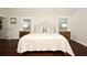 Light filled main bedroom with hardwood floors, bedside tables, and soft, neutral decor at 1653 Cheyenne Trl, Maitland, FL 32751