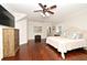 Spacious main bedroom with hardwood flooring, ceiling fan, mounted TV, and dresser at 1653 Cheyenne Trl, Maitland, FL 32751