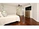 Well-lit main bedroom featuring hardwood flooring, ceiling fan, and mounted TV at 1653 Cheyenne Trl, Maitland, FL 32751