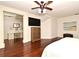 Main bedroom boasts hardwood floors, ceiling fan, and desk workspace at 1653 Cheyenne Trl, Maitland, FL 32751