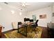 A well-lit home office with a large desk, comfortable seating, and a view of the outdoors at 1653 Cheyenne Trl, Maitland, FL 32751