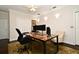 Well-appointed home office with large desk, featuring modern computer setup, and tasteful decor at 1653 Cheyenne Trl, Maitland, FL 32751