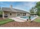 Backyard with a screened-in pool, patio area, and manicured landscaping at 1653 Cheyenne Trl, Maitland, FL 32751