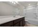 Bathroom featuring single sink vanity and shower over tub at 17319 Million Lakes Ct, Clermont, FL 34714