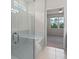 Bathroom featuring walk-in shower with glass door at 17319 Million Lakes Ct, Clermont, FL 34714