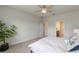 Bright bedroom features neutral walls, carpet, and an ensuite bathroom with a walk-in closet at 17319 Million Lakes Ct, Clermont, FL 34714