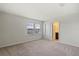 Bedroom with neutral carpet, white walls, dual windows and an ensuite bathroom at 17319 Million Lakes Ct, Clermont, FL 34714