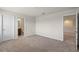 A carpeted bedroom showcasing doors leading to a bathroom and another room at 17319 Million Lakes Ct, Clermont, FL 34714