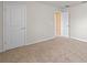 Spacious bedroom with neutral carpet and paint, with a closet door at 17319 Million Lakes Ct, Clermont, FL 34714