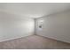 Neutral bedroom with a cozy carpet and window that lets in natural light at 17319 Million Lakes Ct, Clermont, FL 34714