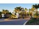 Gated entrance to the community with manicured landscaping and decorative lighting at 17319 Million Lakes Ct, Clermont, FL 34714