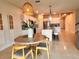 Bright dining area adjacent to a modern kitchen, featuring stylish lighting and island seating at 17319 Million Lakes Ct, Clermont, FL 34714