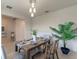 Bright dining room with modern light fixture, comfortable seating, and a view to the entryway at 17319 Million Lakes Ct, Clermont, FL 34714