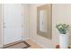Welcoming entryway with a decorative mirror and tile floors, accented by a vase of fresh flowers at 17319 Million Lakes Ct, Clermont, FL 34714
