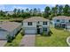 Charming two-story home featuring a brick driveway, manicured lawn, and serene water view at 17319 Million Lakes Ct, Clermont, FL 34714