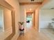 Inviting hallway with neutral tones, decorative mirror, and decorative wood beam at 17319 Million Lakes Ct, Clermont, FL 34714