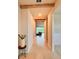 Inviting hallway with a view into the open-concept living area and stylish decorative accents at 17319 Million Lakes Ct, Clermont, FL 34714