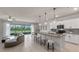 Bright, open-concept kitchen featuring a spacious island, modern appliances, and seamless access to an outdoor patio at 17319 Million Lakes Ct, Clermont, FL 34714