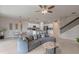 Open living space showcasing a modern kitchen, dining area, and staircase with iron spindles at 17319 Million Lakes Ct, Clermont, FL 34714